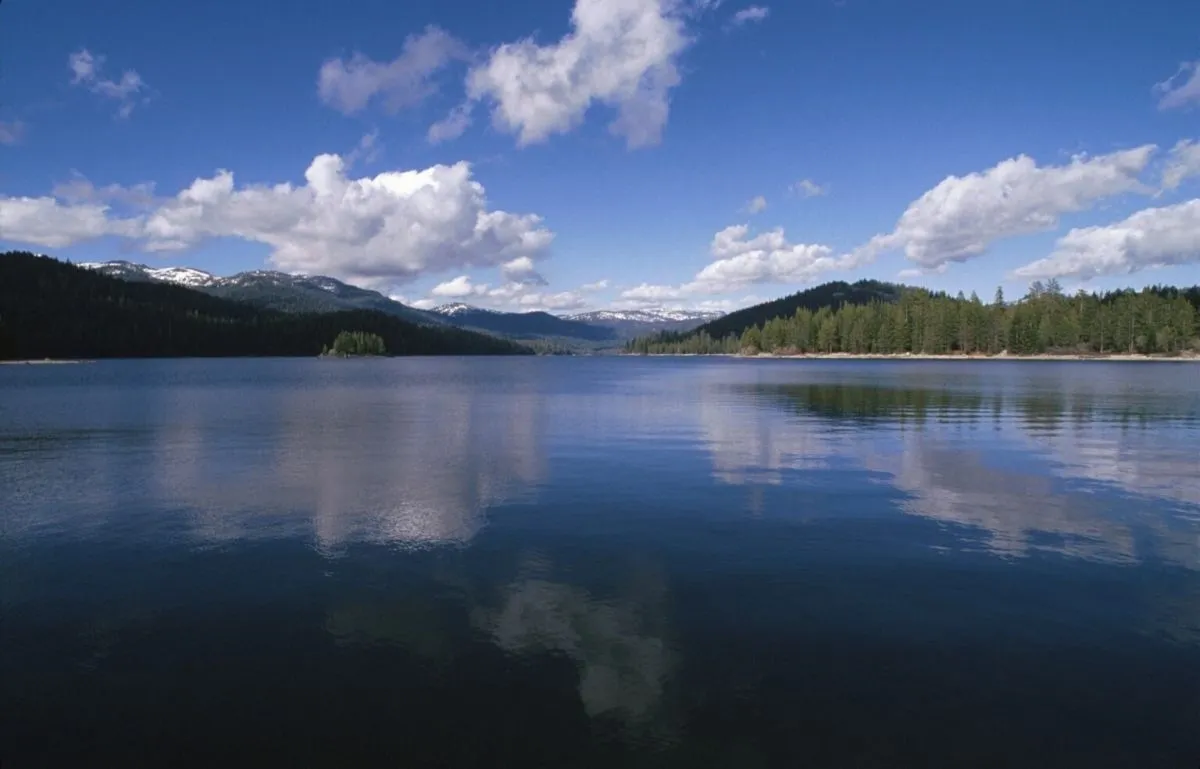 A body of water with mountains in the background.