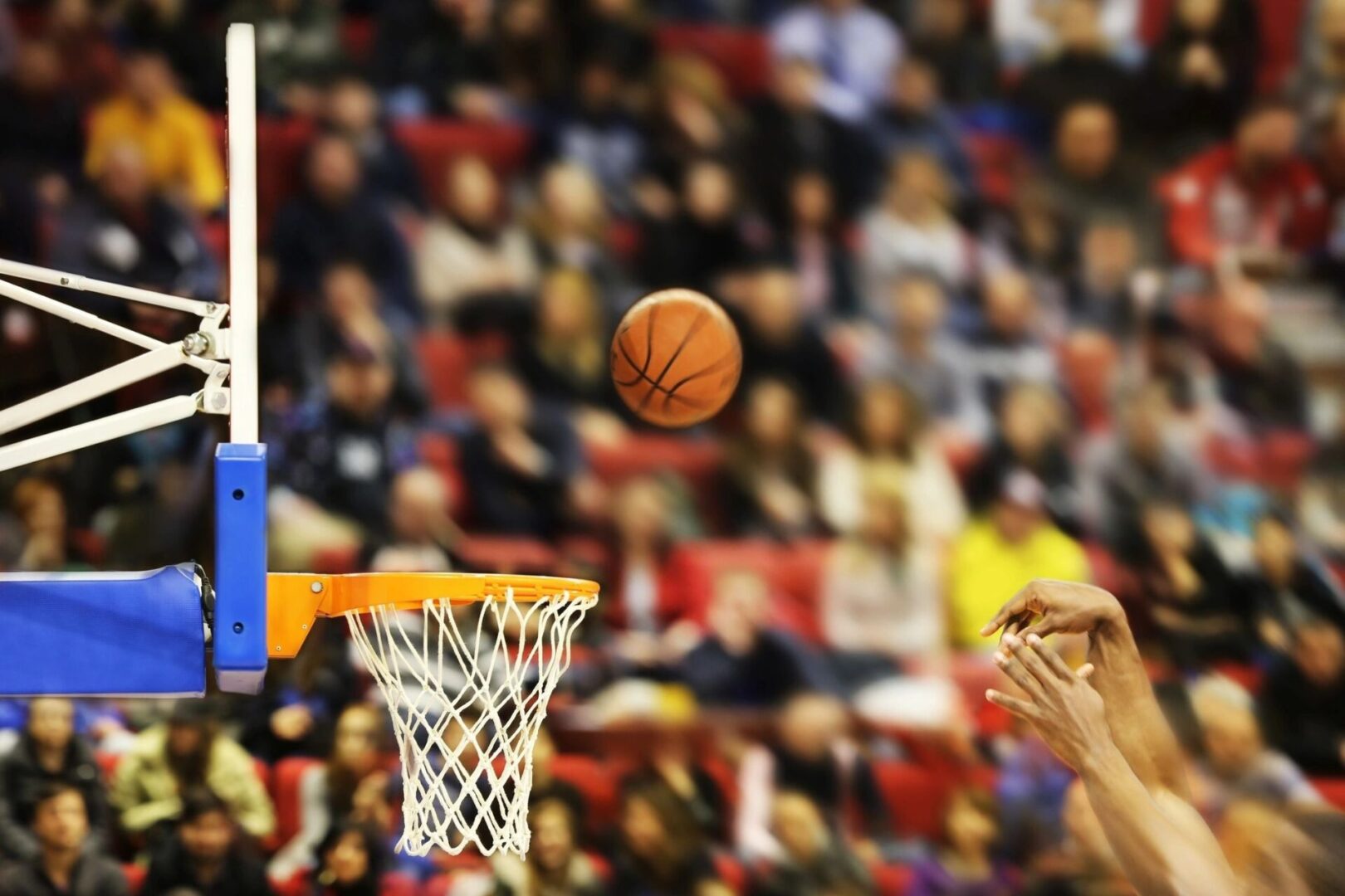 A basketball player is attempting to dunk the ball.