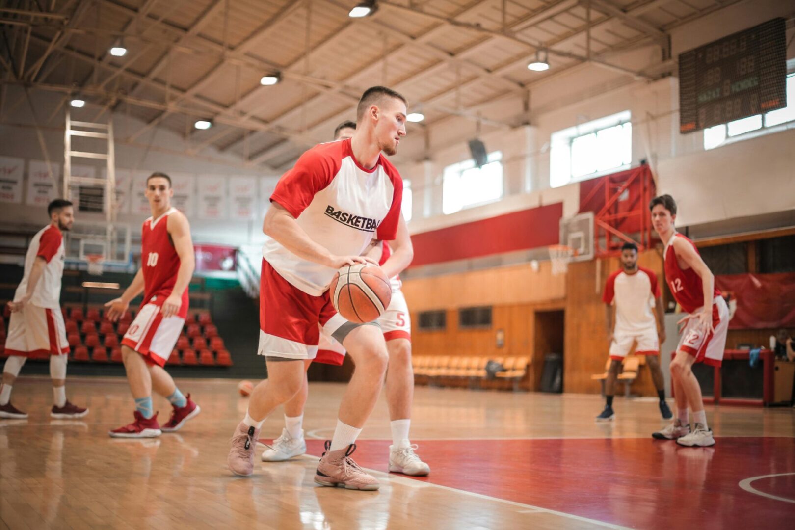 A group of men playing basketball on a court.